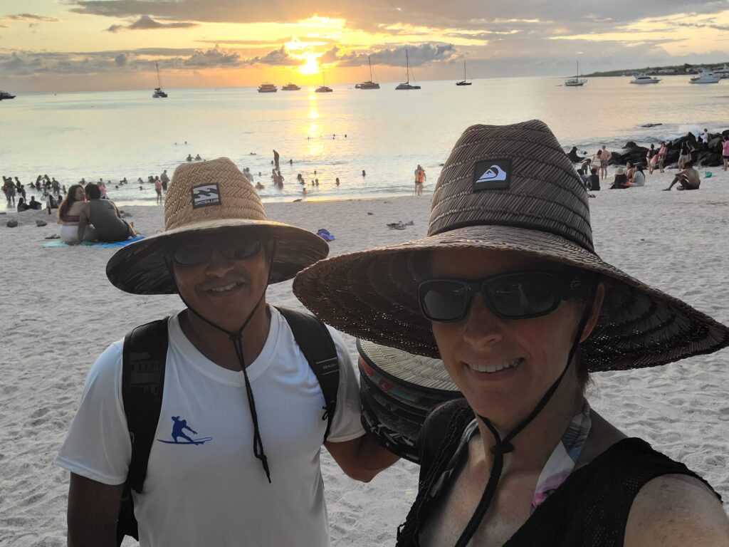 galapagos surf discovery owners on beach at sunset wearing sombreros