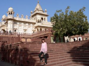 woman on stairs in front of Indian building