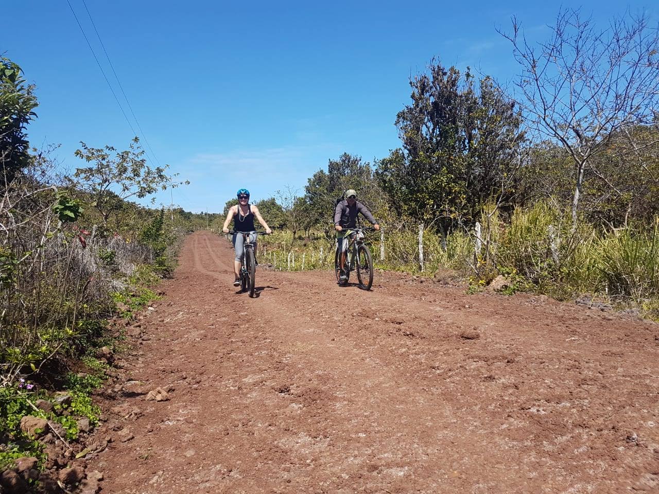 man and woman on bicycles on dirt road