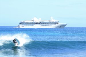 silversea silver origin luxury cruise with surfer in foreground