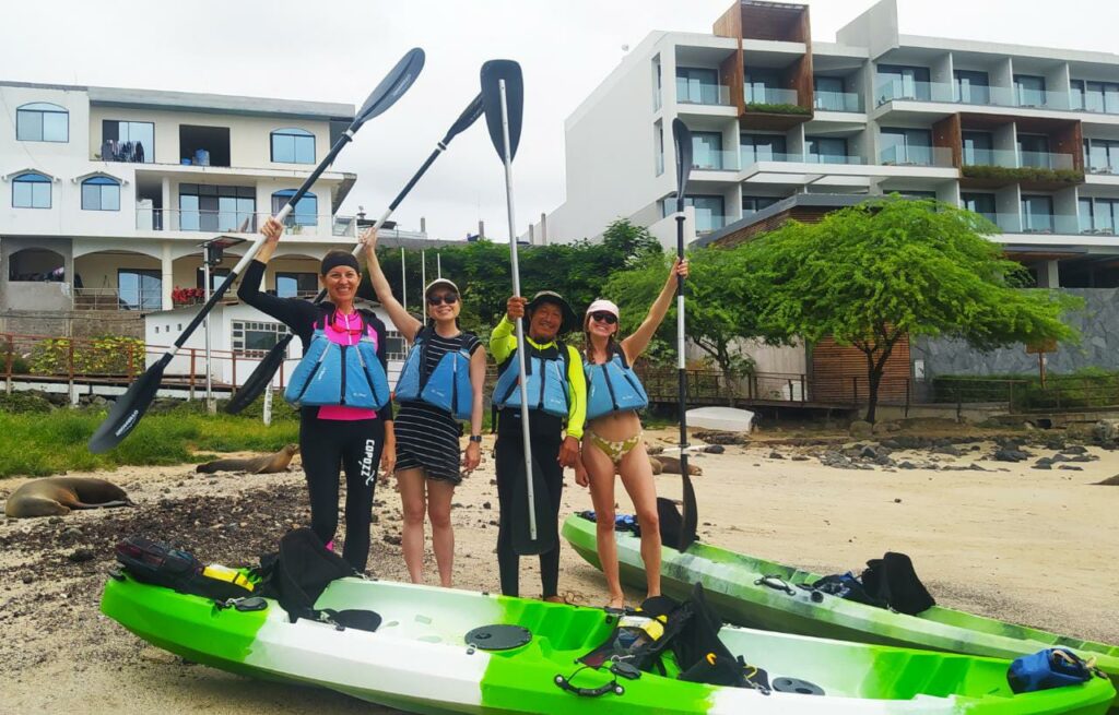 four people prepare to kayak in San Cristobal Galapagos