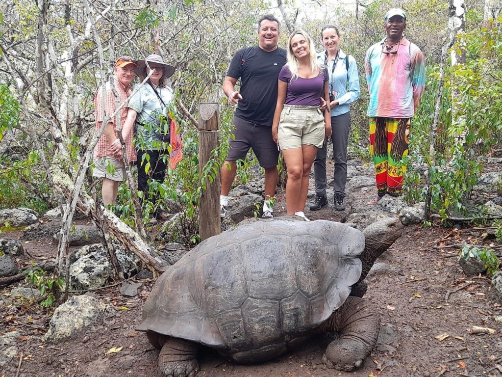 tourists with giant Galapagos tortoise