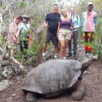 tourists with giant Galapagos tortoise