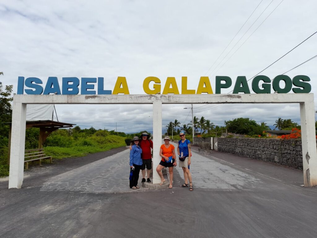 tourists in front of Isabela Galapagos sign