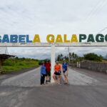 tourists in front of Isabela Galapagos sign