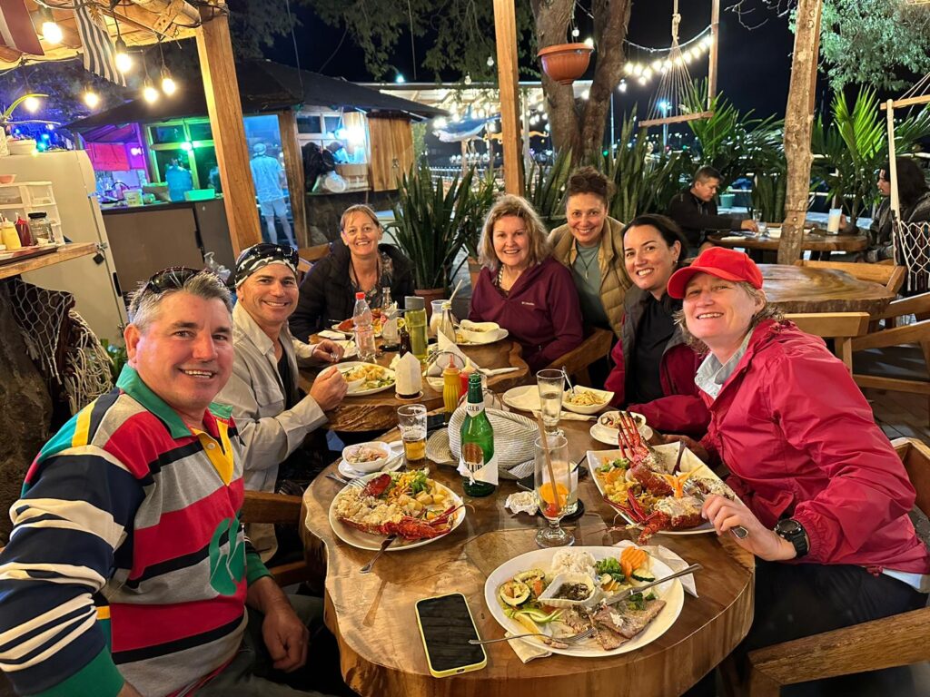 men and women eating dinner at a restaurant in San Cristobal, Galapagos
