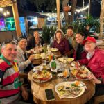 men and women eating dinner at a restaurant in San Cristobal, Galapagos